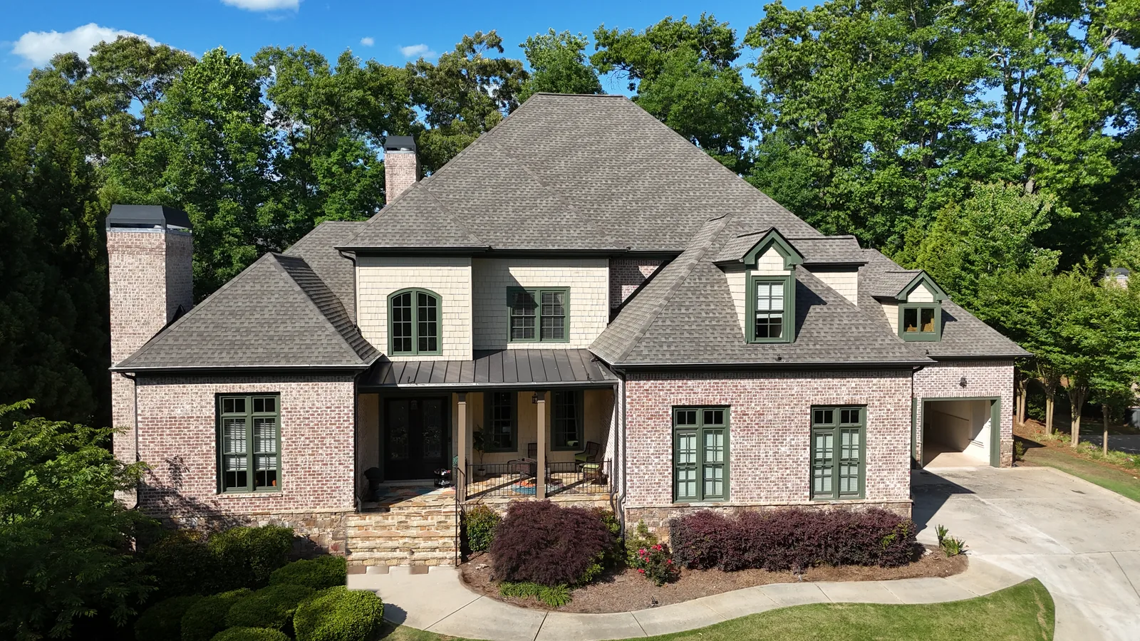 Completed residential roof replacement on a luxury brick home in metro Atlanta
