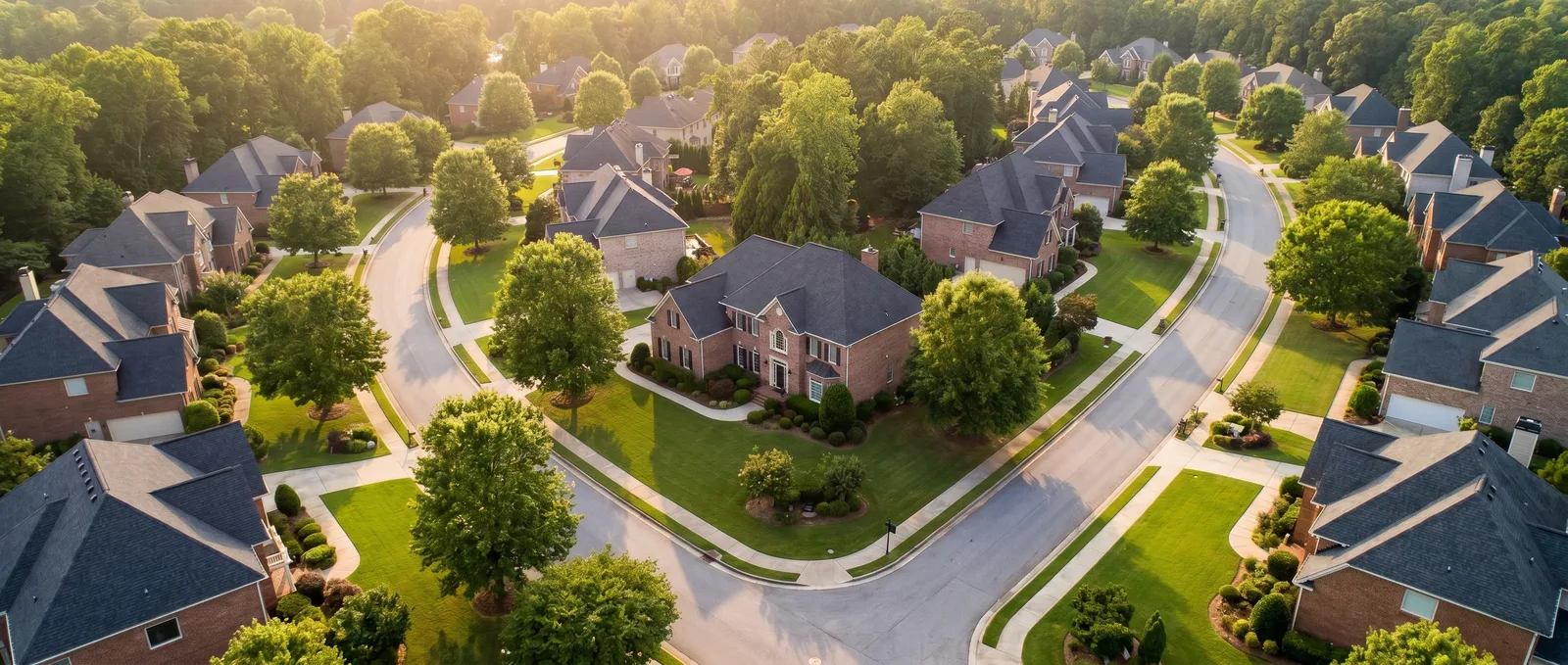 Aerial view of a Suwanee, Georgia neighborhood of large well-maintained homes